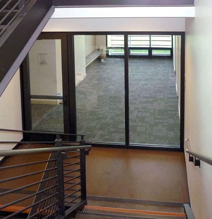 A 2 hour exit enclosure with 90 minute doors. Fire resistive glass is used to bring vision and transparency to the 2 hour exit enclosure/stairwell.
