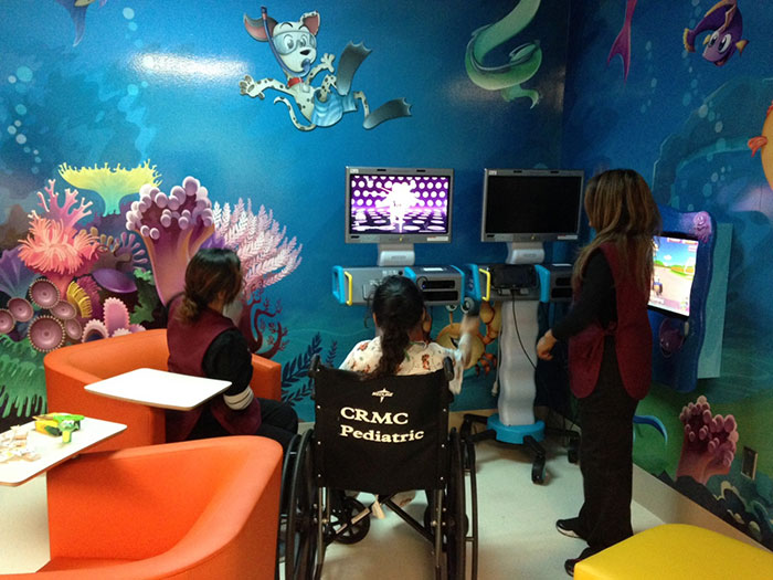 10-year old Eliyana, a patient at the Burn Center, playing with one of the Starlight® Fun Center® mobile entertainment units donated by SAFTI FIRST to provide entertainment to children receiving treatment at the Community Medical Center in Fresno, CA